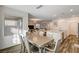 Modern dining area with a glass top table and view into living room at 5969 Viscaya Grove St, Las Vegas, NV 89118