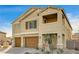 Two-story house with tan siding, brown garage doors, and a landscaped yard at 5969 Viscaya Grove St, Las Vegas, NV 89118