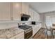 Modern kitchen with white cabinets and granite countertops at 5969 Viscaya Grove St, Las Vegas, NV 89118