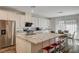 Modern kitchen with white cabinets, granite counters, and stainless steel appliances at 5969 Viscaya Grove St, Las Vegas, NV 89118