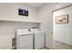 Laundry room with washer, dryer, and shelving at 5969 Viscaya Grove St, Las Vegas, NV 89118