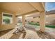 Covered patio with stone tile flooring and seating at 5969 Viscaya Grove St, Las Vegas, NV 89118