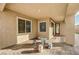 Covered patio with stone tile flooring and seating at 5969 Viscaya Grove St, Las Vegas, NV 89118