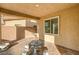 Covered patio with stone tile flooring and seating at 5969 Viscaya Grove St, Las Vegas, NV 89118