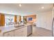 Modern kitchen with island, stainless steel appliances and white cabinets at 6188 Lily Garden St # 110, North Las Vegas, NV 89081