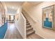 Gray carpeted staircase and hallway with modern wall art at 6188 Lily Garden St # 110, North Las Vegas, NV 89081