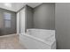 Relaxing bathroom with soaking tub and gray walls at 6332 Ava Ridge Ave, Las Vegas, NV 89141