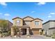 Two-story house with tan exterior, shutters, and attached garage at 6332 Ava Ridge Ave, Las Vegas, NV 89141