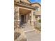 Front entrance with stonework, a dark door, and a paved walkway at 6332 Ava Ridge Ave, Las Vegas, NV 89141