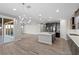 Open kitchen with island and chandelier, overlooking living room at 6332 Ava Ridge Ave, Las Vegas, NV 89141