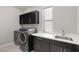 Functional laundry room with washer, dryer, and cabinets at 6332 Ava Ridge Ave, Las Vegas, NV 89141