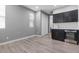 Modern wet bar with dark cabinetry and wine cooler at 6332 Ava Ridge Ave, Las Vegas, NV 89141