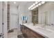 Elegant bathroom with double vanity and a large shower at 6434 Spring Jog St, Las Vegas, NV 89166