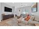 Living room with sectional sofa, large TV, and wood floors at 6434 Spring Jog St, Las Vegas, NV 89166