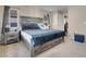 King-size bed with gray wooden frame in a spacious bedroom at 6461 Karlsen Ct, Las Vegas, NV 89122