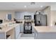 Modern kitchen with gray cabinets, black appliances, and an island at 6461 Karlsen Ct, Las Vegas, NV 89122