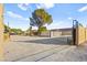 Large backyard with play area, gate, and mature trees at 6480 Darby Ave, Las Vegas, NV 89146