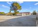 Spacious backyard playground with mature trees and a partial view of the house at 6480 Darby Ave, Las Vegas, NV 89146