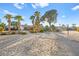 Sandy backyard with palm trees, volleyball and play area at 6480 Darby Ave, Las Vegas, NV 89146