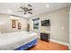 Bedroom with king-size bed, TV, and ceiling fan at 6480 Darby Ave, Las Vegas, NV 89146