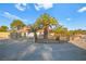 Side view of single-story home with palm trees and wrought iron fence at 6480 Darby Ave, Las Vegas, NV 89146