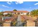 Single story home with red tile roof and landscaped yard at 6480 Darby Ave, Las Vegas, NV 89146