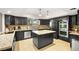 Modern kitchen with dark cabinetry, granite counters, and island at 6480 Darby Ave, Las Vegas, NV 89146