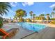 Sparkling pool surrounded by lounge chairs and palm trees at 6480 Darby Ave, Las Vegas, NV 89146