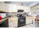 Kitchen with white cabinets and appliances at 6770 Laronda Ln, Las Vegas, NV 89156