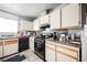 Galley kitchen with appliances at 6770 Laronda Ln, Las Vegas, NV 89156