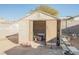 Beige plastic storage shed with double doors, partially filled with items at 6770 Laronda Ln, Las Vegas, NV 89156