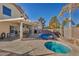 Inviting backyard oasis featuring a sparkling pool, spa, and covered patio at 716 Amber Hills Dr, Las Vegas, NV 89123