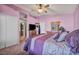 Spacious bedroom with neutral walls and carpet, featuring a large bed and TV at 716 Amber Hills Dr, Las Vegas, NV 89123