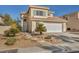 Two-story house with landscaped yard, two-car garage, and neutral color scheme at 716 Amber Hills Dr, Las Vegas, NV 89123