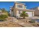 Two-story house with landscaped yard, two-car garage, and neutral color scheme at 716 Amber Hills Dr, Las Vegas, NV 89123