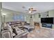 Living room with a large sectional sofa, fireplace, and built-in entertainment center at 716 Amber Hills Dr, Las Vegas, NV 89123