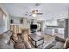 Open living room features a fireplace, kitchen island, and neutral tile floors at 716 Amber Hills Dr, Las Vegas, NV 89123