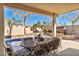 Covered patio overlooks a refreshing pool and lush landscaping at 716 Amber Hills Dr, Las Vegas, NV 89123