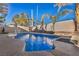 Inviting kidney-shaped swimming pool surrounded by a spacious patio at 716 Amber Hills Dr, Las Vegas, NV 89123