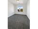 Bright bedroom featuring gray carpet and a large window at 7355 Sunray Point St, North Las Vegas, NV 89084