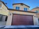 Two story home with a burgundy garage door at 7355 Sunray Point St, North Las Vegas, NV 89084