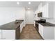 Modern kitchen with white cabinets, granite countertops, and stainless steel appliances at 7355 Sunray Point St, North Las Vegas, NV 89084