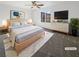 Virtually staged main bedroom with light wood furniture and neutral decor at 7355 Sunray Point St, North Las Vegas, NV 89084