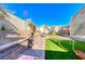 Landscaped backyard with artificial turf, playset and trampoline at 8125 Caramel Gorge Ct, Las Vegas, NV 89143