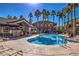 Community pool with palm trees and lounge chairs at 8805 Jeffreys St # 2019, Las Vegas, NV 89123