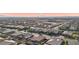 Aerial view of houses and a construction site in the distance at 9802 Summer Bliss Ave, Las Vegas, NV 89149