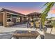 Outdoor entertainment area with fire pit and gazebo at 9802 Summer Bliss Ave, Las Vegas, NV 89149