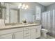 Double vanity bathroom with a shower/tub combo and gray tile flooring at 9802 Summer Bliss Ave, Las Vegas, NV 89149