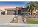 Single-story home with desert landscaping and a two-car garage at 9802 Summer Bliss Ave, Las Vegas, NV 89149