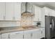 Kitchen with stainless steel appliances and mosaic backsplash at 9802 Summer Bliss Ave, Las Vegas, NV 89149